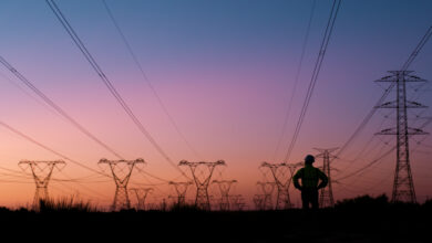 Power lines, thinking and silhouette of person at sunset for electricity, circuit cables and voltage wires. Engineering, construction and technician for maintenance, infrastructure and installation