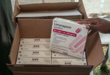 A man holds a packaging containing lenacapavir, a long-