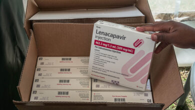 A man holds a packaging containing lenacapavir, a long-