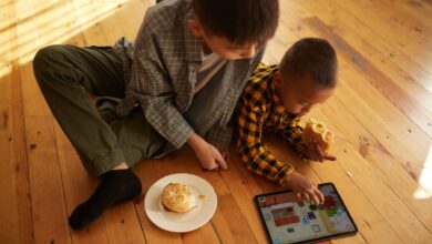 Two boys with burgers playing on the iPad