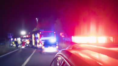 Red flashing light on ambulance car while responding at traffic accident at night