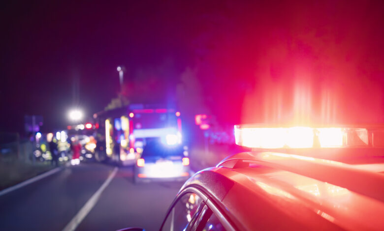 Red flashing light on ambulance car while responding at traffic accident at night