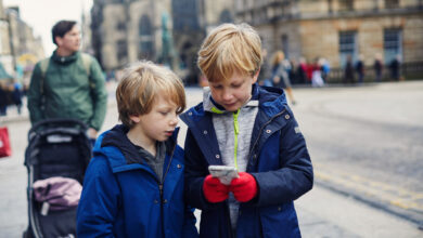 Children looking at a smart phone together