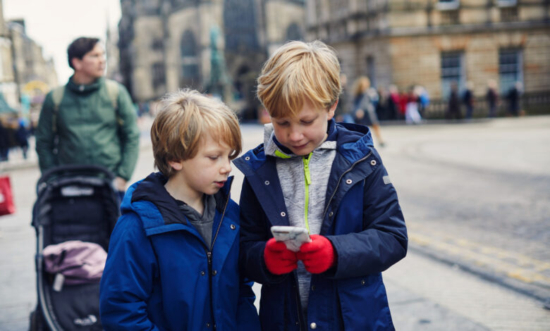 Children looking at a smart phone together