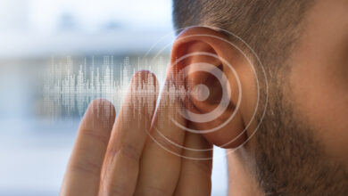 Young man with hearing problems or hearing loss. Hearing test concept.