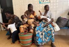 Mothers wait with their children at the Cissin 17 health centre in Ouagadougou, ahead of vaccination and weighing sessions.