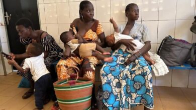 Mothers wait with their children at the Cissin 17 health centre in Ouagadougou, ahead of vaccination and weighing sessions.