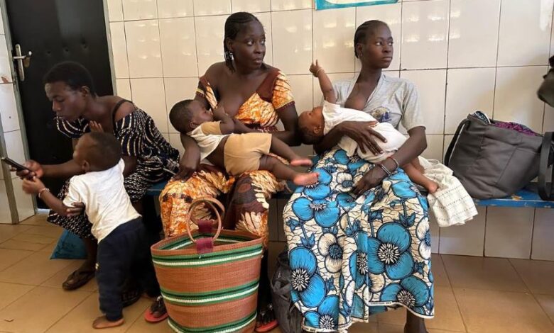 Mothers wait with their children at the Cissin 17 health centre in Ouagadougou, ahead of vaccination and weighing sessions.