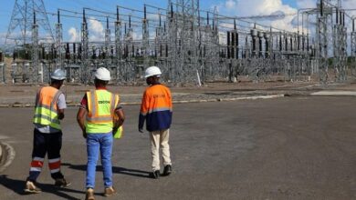 Electricity Supply Corporation of Malawi workers walk through a power substation that helps transmit and distribute electricity to homes and businesses.