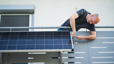 man mounting solar panel on balcony