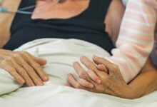 cancer patient with daughter who hold her hands