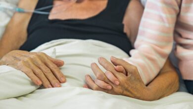 cancer patient with daughter who hold her hands