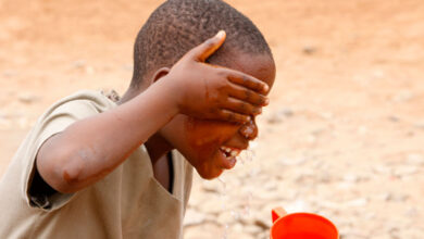 Boy washing his face