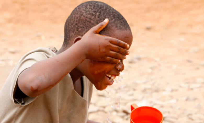 Boy washing his face