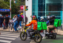 Didi Food and Uber Eats delivery drivers on motorcycles in the streets of Mexico City