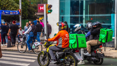 Didi Food and Uber Eats delivery drivers on motorcycles in the streets of Mexico City