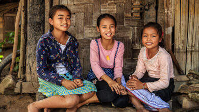 Three Laotian little girls in a village in Northern Laos