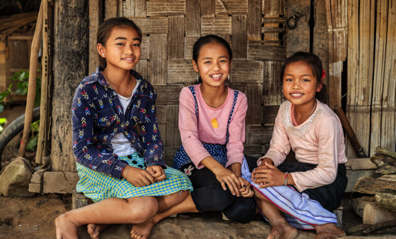 Three Laotian little girls in a village in Northern Laos