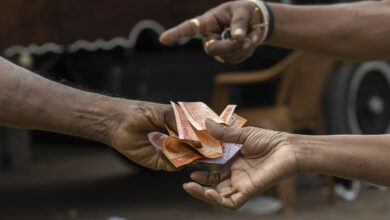A Person Hands Over Sri Lankan Rupee Banknotes