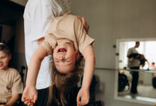 Father holding carefree daughter at home