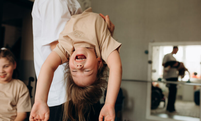 Father holding carefree daughter at home
