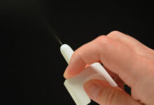 Naloxone nasal spray from emergency overdose kit bag used for recovery from narcotic opioid medications or street drugs overdose.