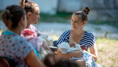 Young mothers breastfeeding in Park