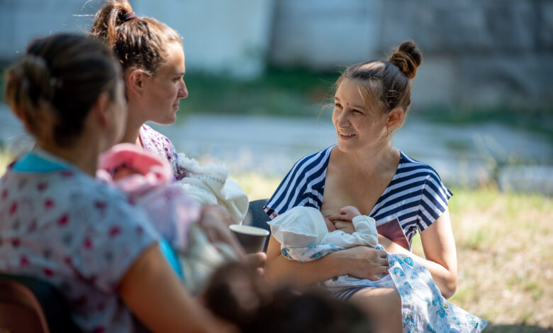Young mothers breastfeeding in Park