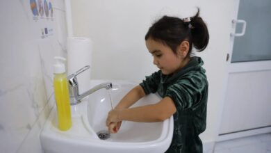 Girl in Tajikistan washes her hands