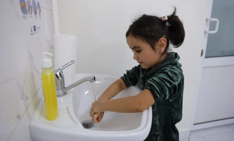 Girl in Tajikistan washes her hands