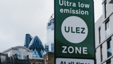 Signs indicating Ultra Low Emission Zone (ULEZ) on a street in London, UK.