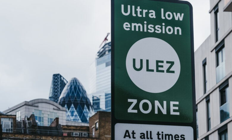 Signs indicating Ultra Low Emission Zone (ULEZ) on a street in London, UK.