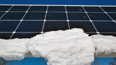 snow melting on solar panels in sunshine