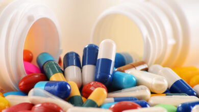 Composition with variety of drug pills and container