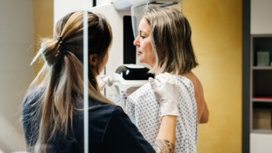 Nurse Assisting Patient During Mammogram