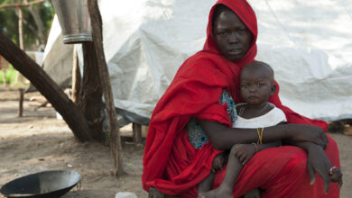 A woman holds her child in a refugee camp in South Sudan.